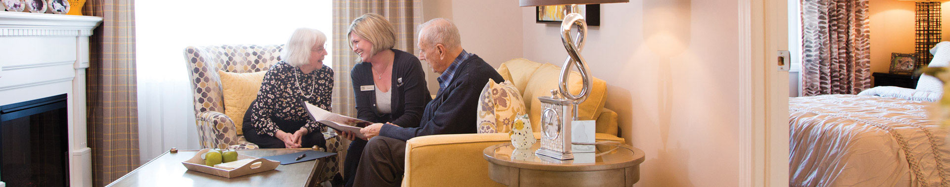 A seasons staff chatting with residents in their room